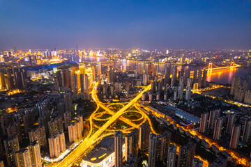 Obraz premium Wuhan china city skyline at night glows with many lights and busy roads.