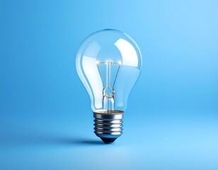 Clear Incandescent Light Bulb Centered on a Vibrant Blue Background.
