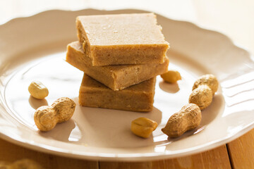 A stack of Paçoca and Raw Peanuts: A Traditional Brazilian Peanut Candy