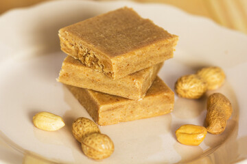 A stack of Paçoca and Raw Peanuts: A Traditional Brazilian Peanut Candy