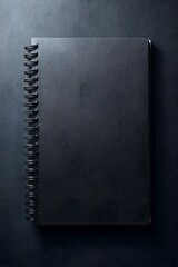 Black notebook on a dark surface.