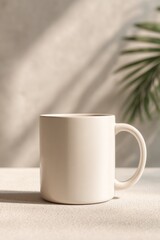Fototapeta premium Plain white ceramic mug with a curved handle placed on a light , casting a shadow in a minimalist setting