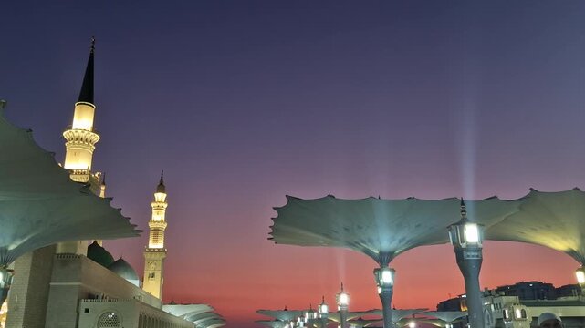 Static view of giant umbrellas of Nabawi mosque during early morning sunrise in Medina, Kingdom of Saudi Arabia.