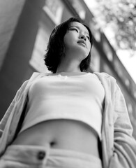 Young woman looking up in monochrome analog medium format film photography