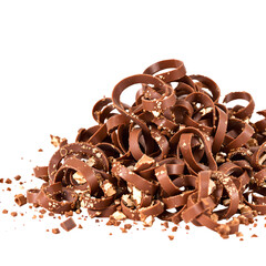 A delightful pile of gourmet milk chocolate curls with crunchy nut pieces, perfect for dessert toppings and baking, isolated on a white background.