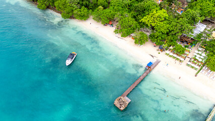 Stunning aerial shot of Rosario Island's beach, showcasing turquoise waters, lush greenery, and a...