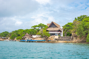 Beautiful landscape of Rosario Island, featuring traditional huts and lush greenery, perfect for...