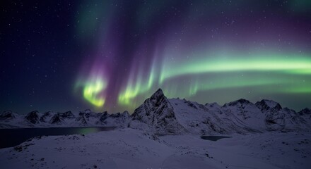 Vivid Green and Purple Aurora Borealis Dances Above a Jagged Snowy Mountain Peak