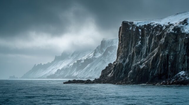 Majestic snowy cliffs rise above serene ocean waters in an ethereal and dramatic coastal landscape during winter solitude