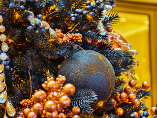 Sparkling Christmas tree decorations adorned with shimmering ornaments and festive berries create a...