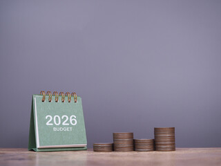 2026 desk calendar and stack of coins. The concept about budget planning and allocation in year 2026