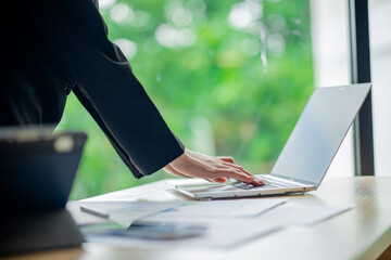 Business colleagues analyzing documents and charts at an office desk, focusing on planning, teamwork, financial analysis, cooperation, and decision-making.