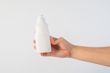 White bottle product in hand on white background
