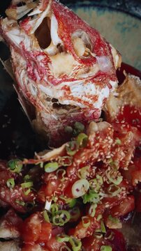 vertical 4k close up video asian style deep fried snapper with raspberry balsamic sauce served on plate in restaurant