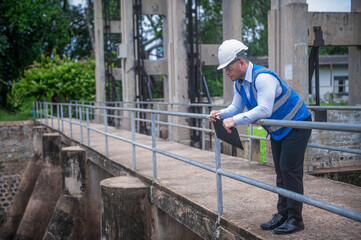 A skilled engineer is inspecting the structure of a water gate of a large river.