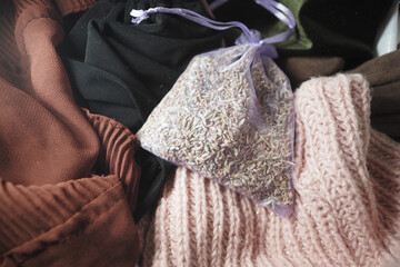 Lavender sachet resting among cozy knit fabrics