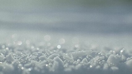 Winter snowfall close-up featuring delicate ice crystals sparkling in sunlight, creating a serene and cold seasonal atmosphere with a shallow depth of field. - Powered by Adobe