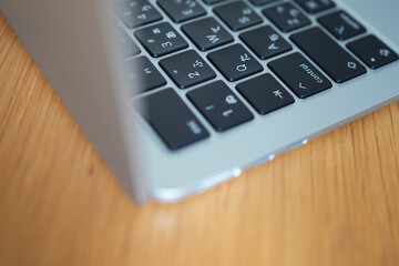 Open Laptop Close-Up on Wooden Desk — Sleek Keyboard, Bright Minimal Workspace