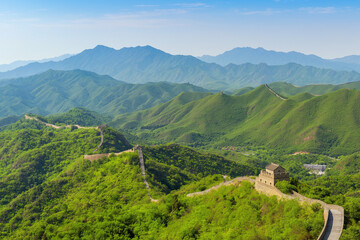 Great Wall of China winding through green mountains, panoramic scene