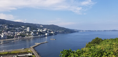 Scenic View of Atami Cityscape Blending the Sparkling Sea with a Vibrant Urban Landscape