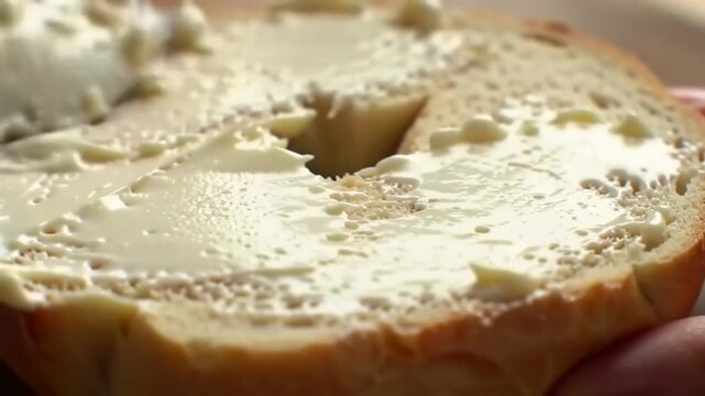 Close-up of buttered bagel slice