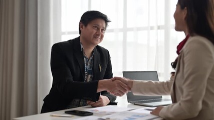 Business people shaking hands after successful meeting