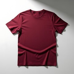 Stylish maroon cotton t-shirt flat lay mockup with shadow overlay for apparel branding and print design presentation.