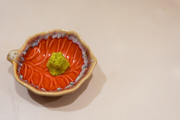 Hot green wasabi paste in bowl. Close up