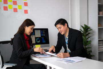 Business people analyzing charts and reports in office meeting