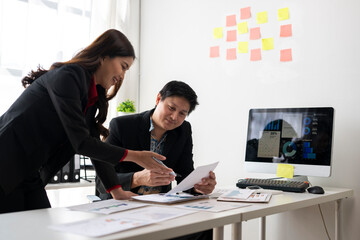 Business people working together in modern office analyzing financial charts and reports