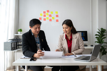 Business people working together in modern office analyzing charts and documents