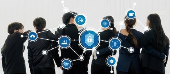 A group of diverse professionals stands together in business attire, collaborating on cybersecurity solutions surrounded by digital icons representing protection and networking concepts. Amity