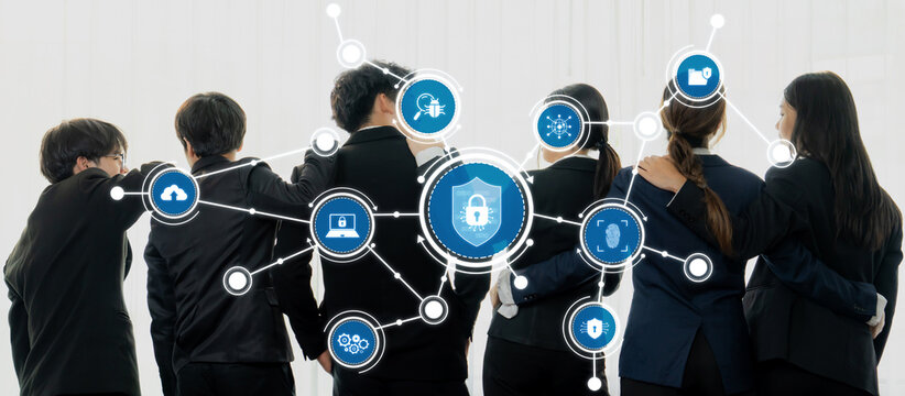 A group of diverse professionals stands together in business attire, collaborating on cybersecurity solutions surrounded by digital icons representing protection and networking concepts. Amity