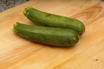 Two Zucchinis on Wooden Cutting Board