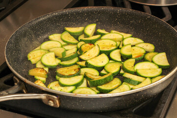 Closeup of Sliced Zucchini Sautéing in Frying Pan