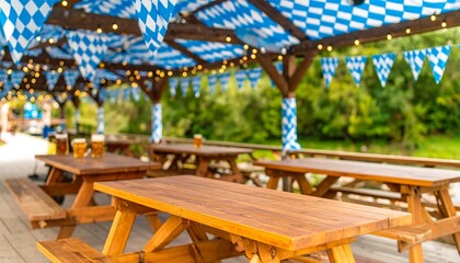 Outdoor beer garden with wooden picnic tables, blue and white Bavarian decorations, and string lights, creating a festive atmosphere.