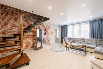 stylish interior showcases a modern living room with a brick accent wall, a unique wooden...