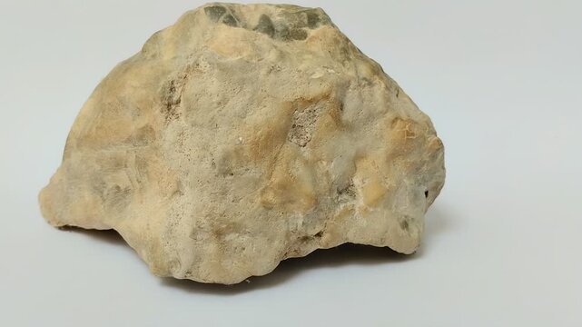 Agate on a white background. A type of microcrystalline quartz from the chalcedony group that has a layered or striped appearance with various colors and patterns.