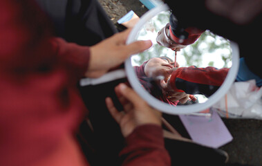 A makeup artist applies cosmetics to a model's face.