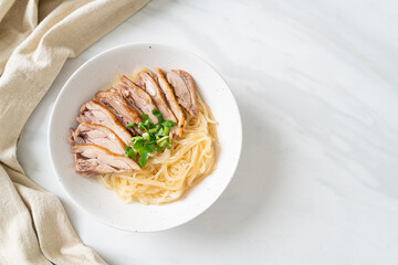 dried noodles with stewed duck in white bowl