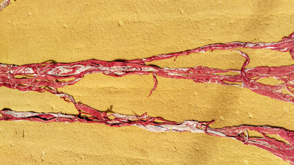 Close-up of damaged sponge mattress with torn fabric layer, showing worn texture and exposed...