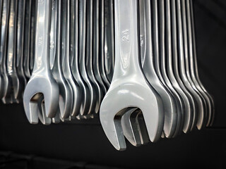 A set of neatly arranged open-end wrenches hangs, showing off its shiny chrome finish. The wrenches...