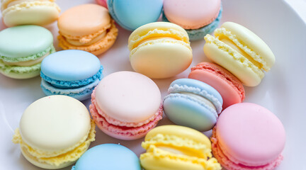 Obraz premium Assorted colorful macarons on a white plate