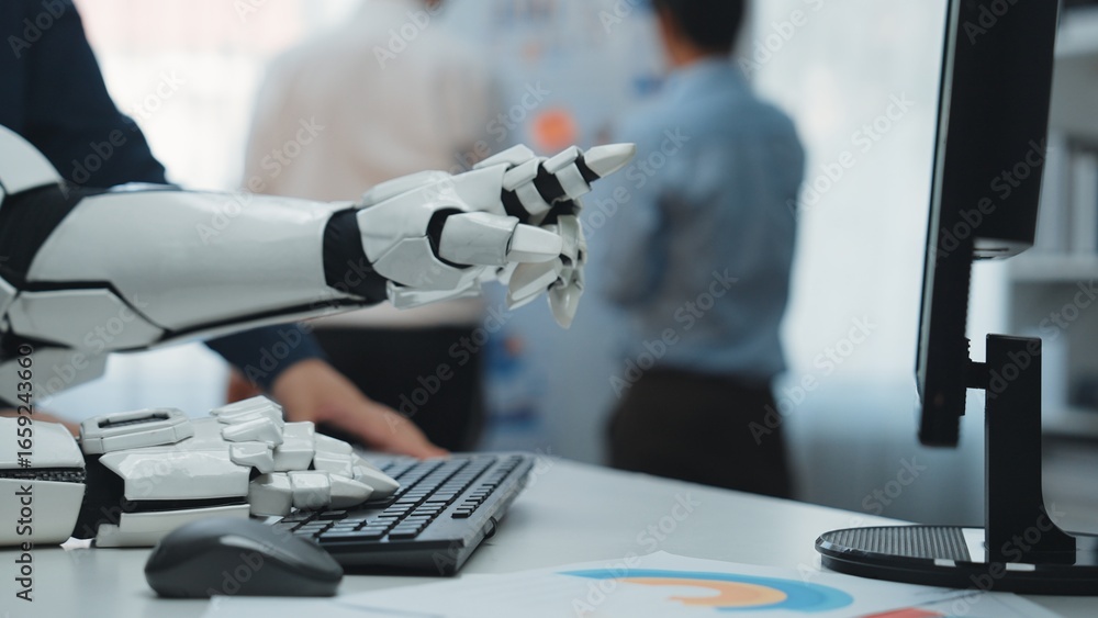 Poster a futuristic robotic hand reaches out to interact with a computer in a modern office, symbolizing th