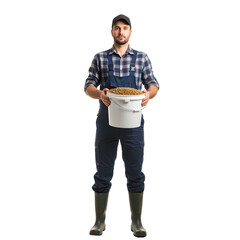 Man in overalls  boots holds a bucket of feed posing on white or transparent background