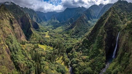 Obraz premium Lush valley with waterfall, dramatic mountains