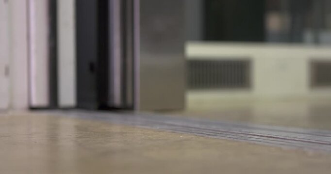 Person walking in and out of elevator that opens then closes 4k