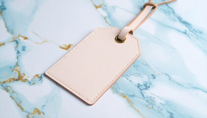 Elegant beige leather travel tag template with a strap, empty for personal details or mockup, on a stylish marbled surface