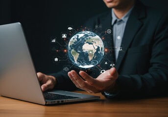 Businessman holding holographic Earth with global connections over laptop