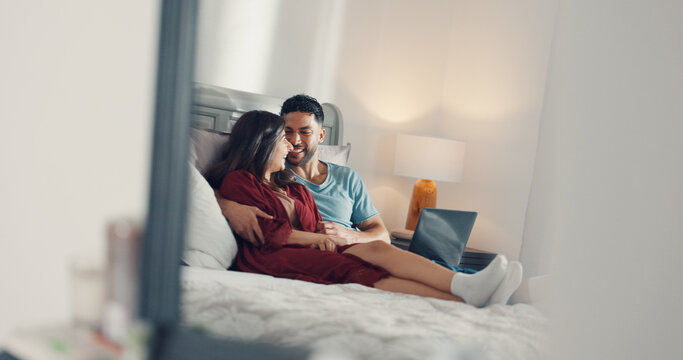 Happy, relax and couple on bed in home with laptop for watching movie, series or show together. Smile, love and man with woman in bedroom for streaming film on computer for bonding in apartment.